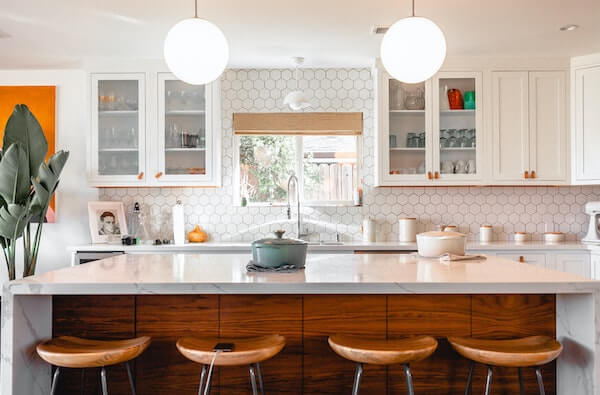 four brown stools in a white kitchen