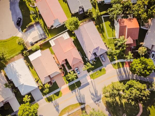 aerial view of suburban homes and green trees