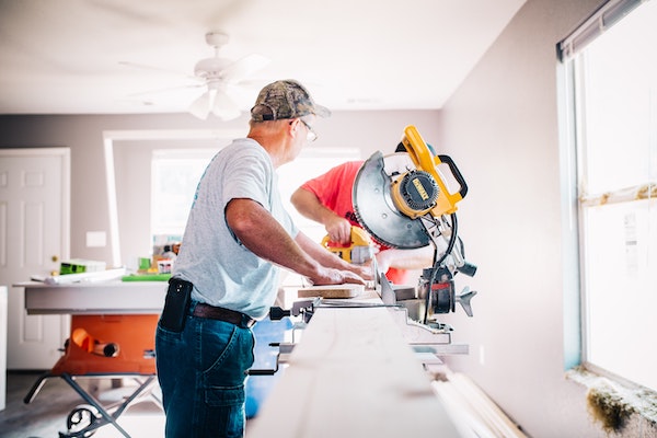 man standing in front of a miter saw