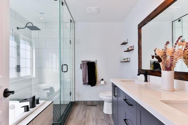 modern bathroom with a stand-alone shower, bathtub, and white sink