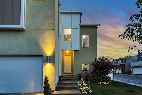 A modern home with the porch light on