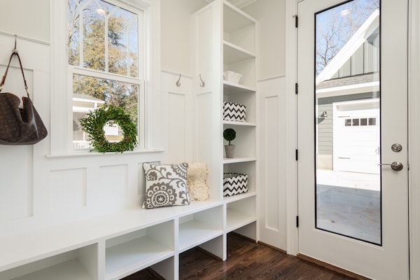 entryway with white shelving and a bench